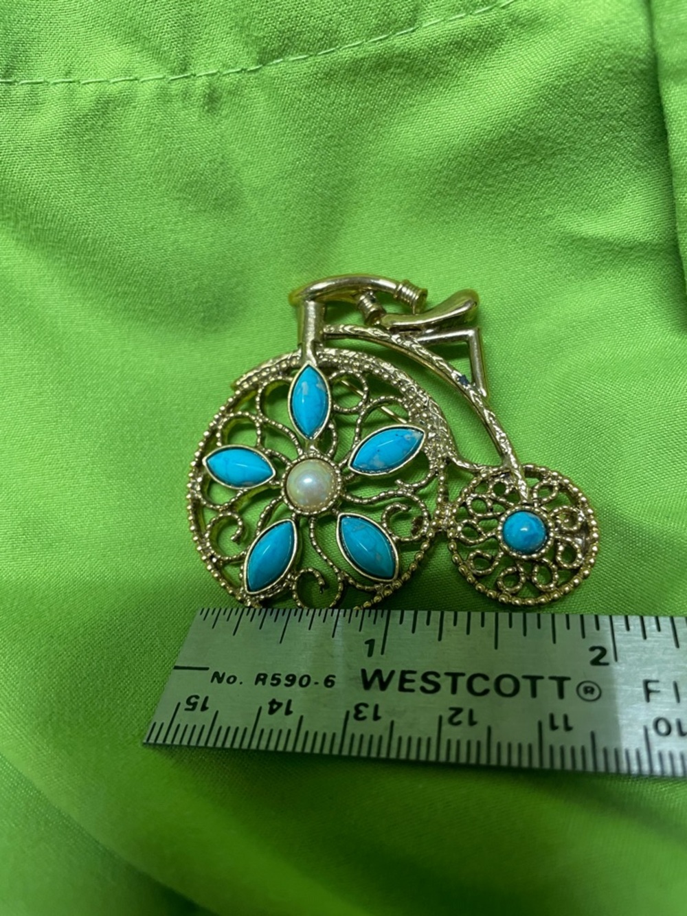 Large tricycle pin, blue fake turquoise, and pearl. Very nice large piece.